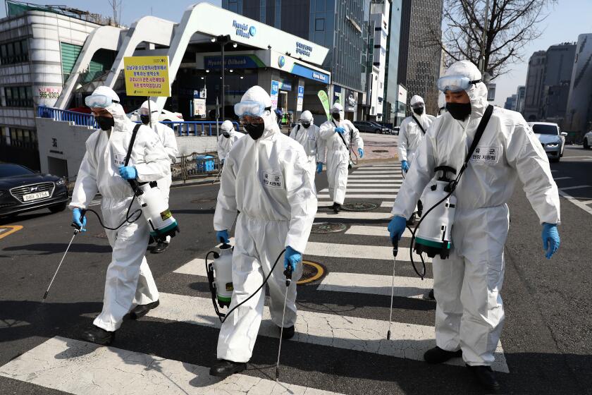 SEOUL, SOUTH KOREA - MARCH 06: South Korean soldiers wearing protective gear, spray antiseptic solution against the coronavirus (COVID-19) in Gangnam district on March 06, 2020 in Seoul, South Korea. The South Korean government has raised the coronavirus alert to the "highest level" as confirmed case numbers continue to rise across the country. According to the Korea Centers for Disease Control and Prevention, 518 new cases were reported on Monday, with the death toll rising to 43. The total number of infections in the nation is currently 6,284, the highest outside of China. (Photo by Chung Sung-Jun/Getty Images)