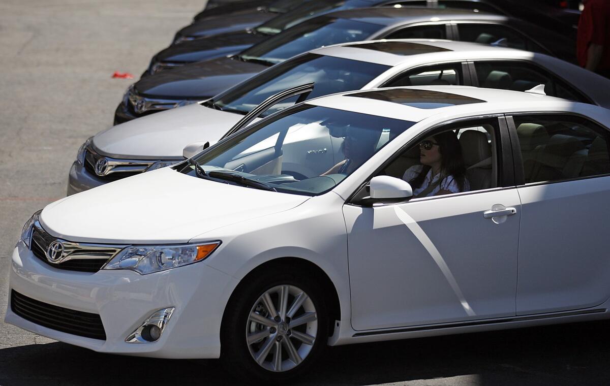 New-generation Toyota Camrys are lined up during an unveiling ceremony on the Paramount Studios lot in Los Angeles.