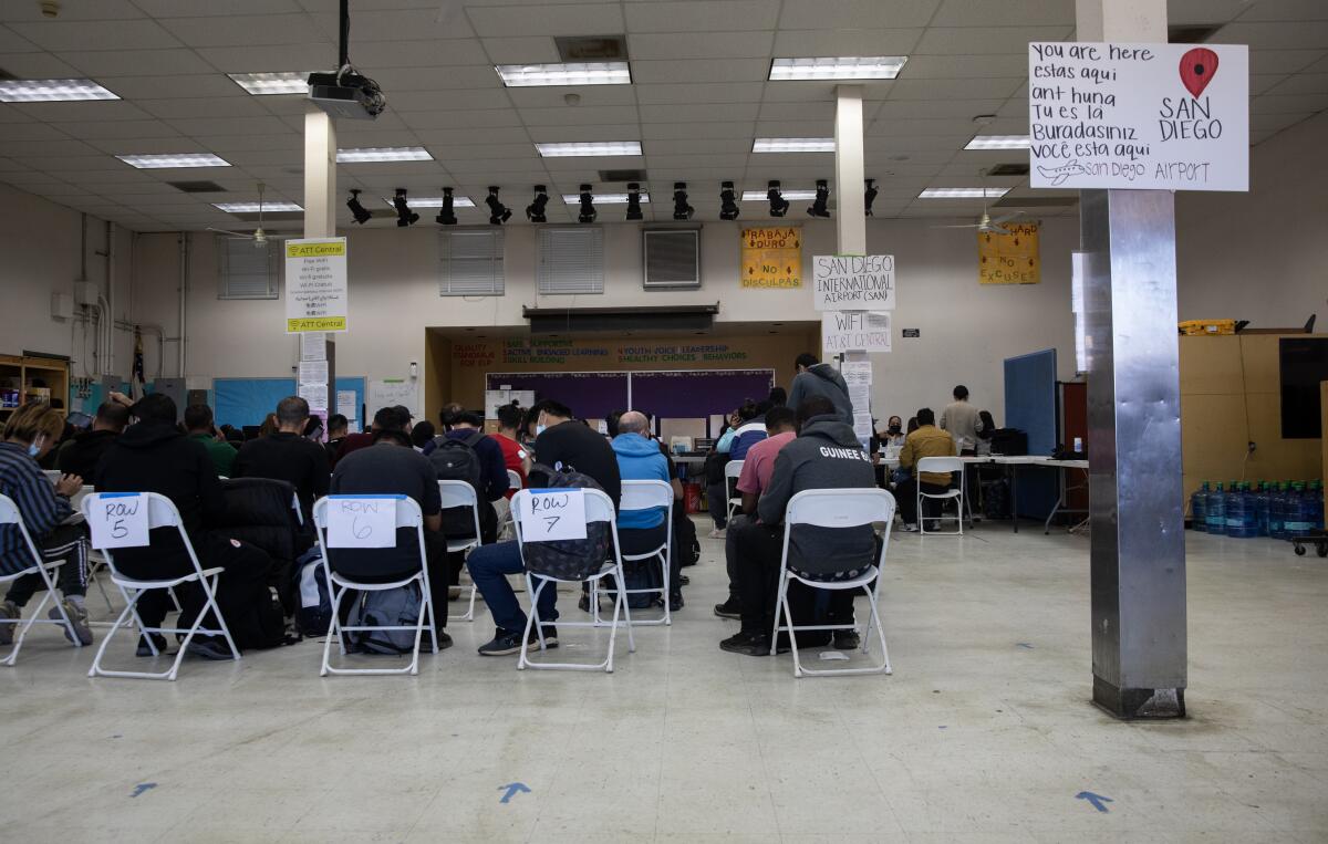 Migrants wait to receive services at the welcome center on Dec. 6.