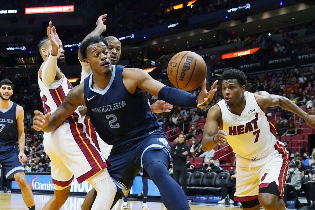 Memphis Grizzlies center Xavier Tillman (2) goes after a loose ball during the first half of an NBA basketball game against the Miami Heat, Monday, Dec. 6, 2021, in Miami. (AP Photo/Marta Lavandier)