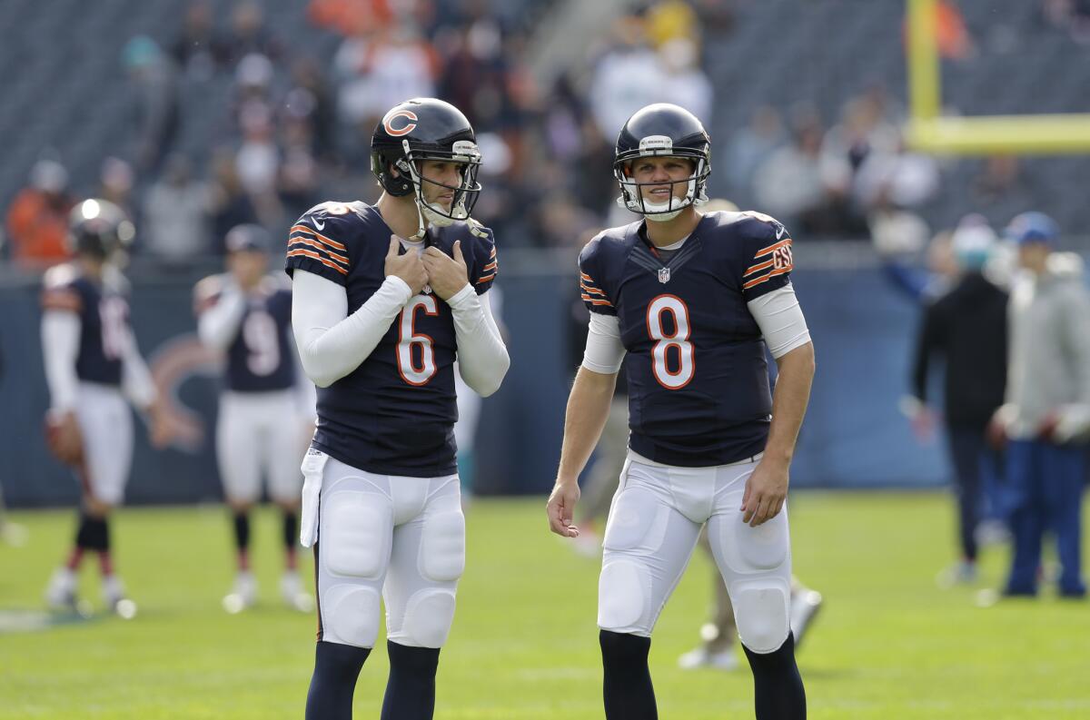 Bears quarterbacks Jimmy Clausen, right, and Jay Cutler talks before an Oct. 19 game in Chicago.