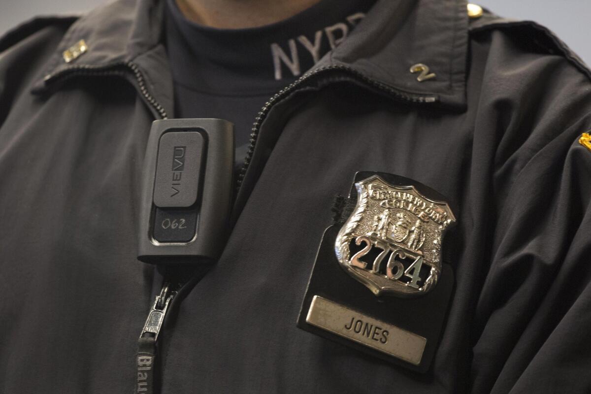 NYPD Officer Joshua Jones wears a VieVu body camera on his chest during a news conference in New York.