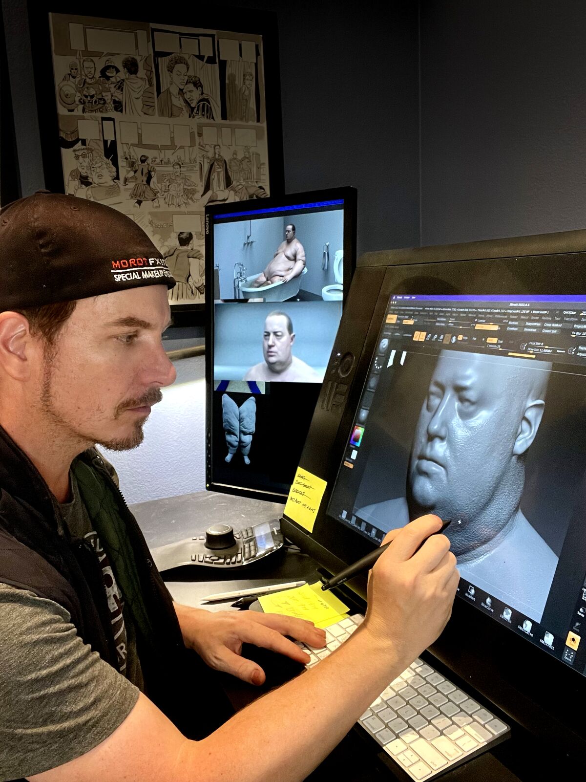 A man works on a computer image.