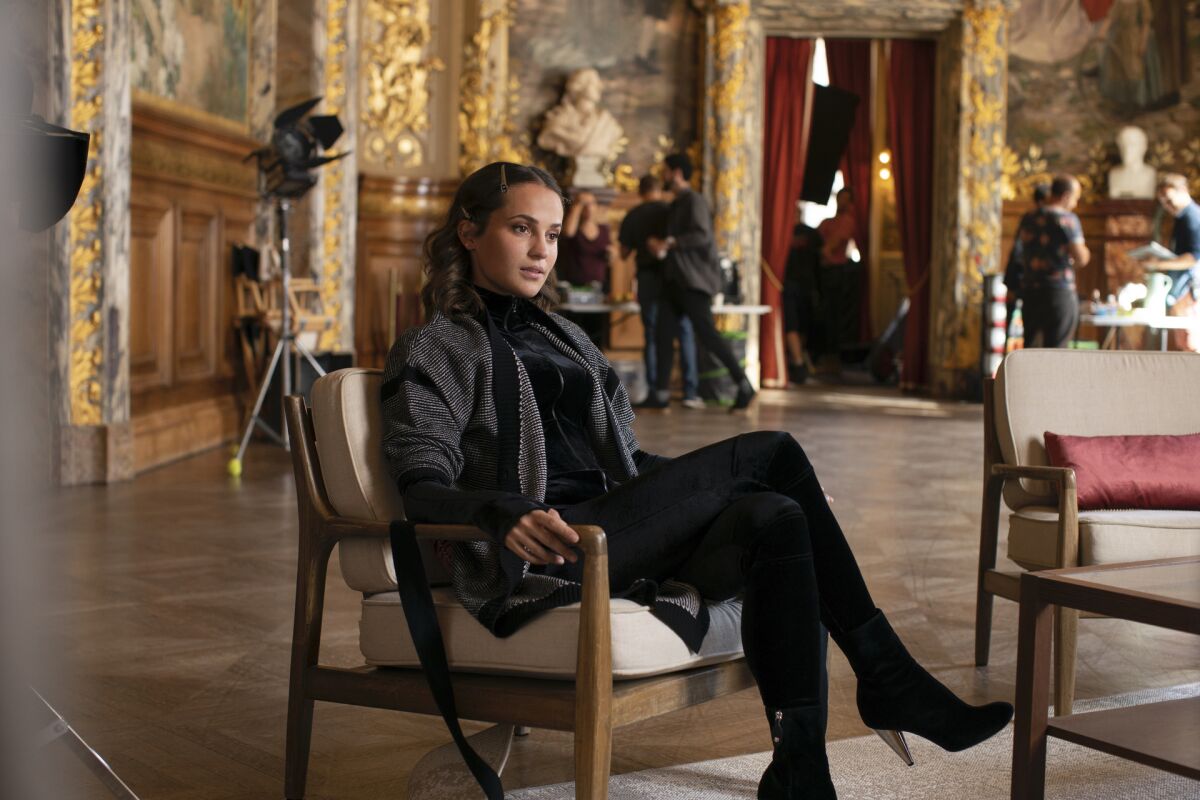 Alicia Vikander sits on a film set in the HBO series "Irma Vep."