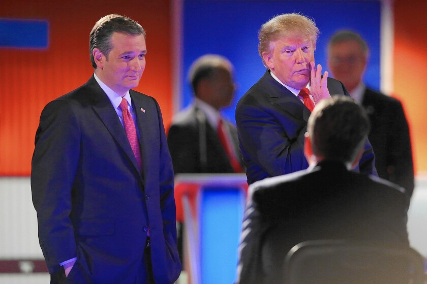Sen. Ted Cruz of Texas and Donald Trump speak to the moderators during a break in Thursday's Republican presidential debate.