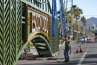 March 3, 2020, Escondido, California_USA_| Workers prepare the new Escondido Giving Arch for its installation over Grand Ave. at Center City Parkway in downtown Escondido in this view looking east. |_Photo Credit: Photo by Charlie Neuman