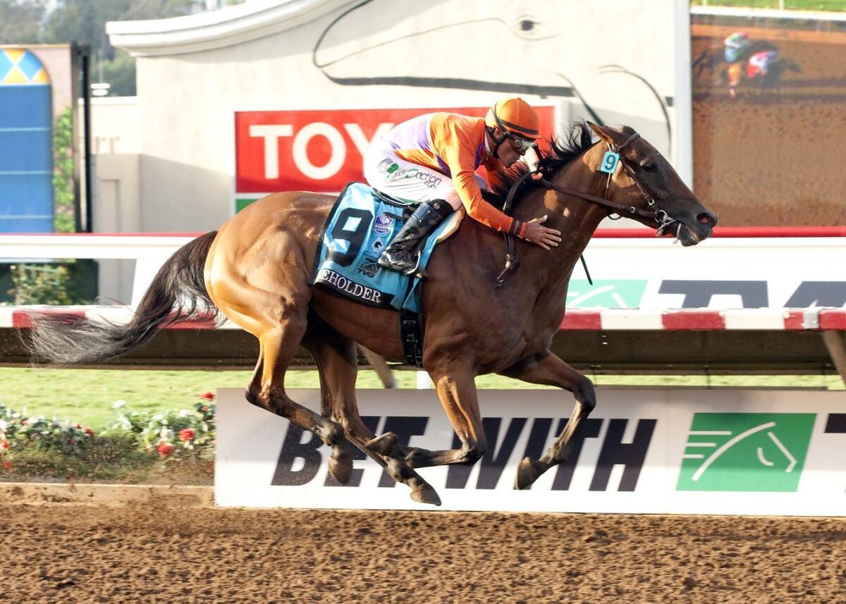 Beholder and jockey Gary Stevens win the Pacific Classic at Del Mar on Saturday.