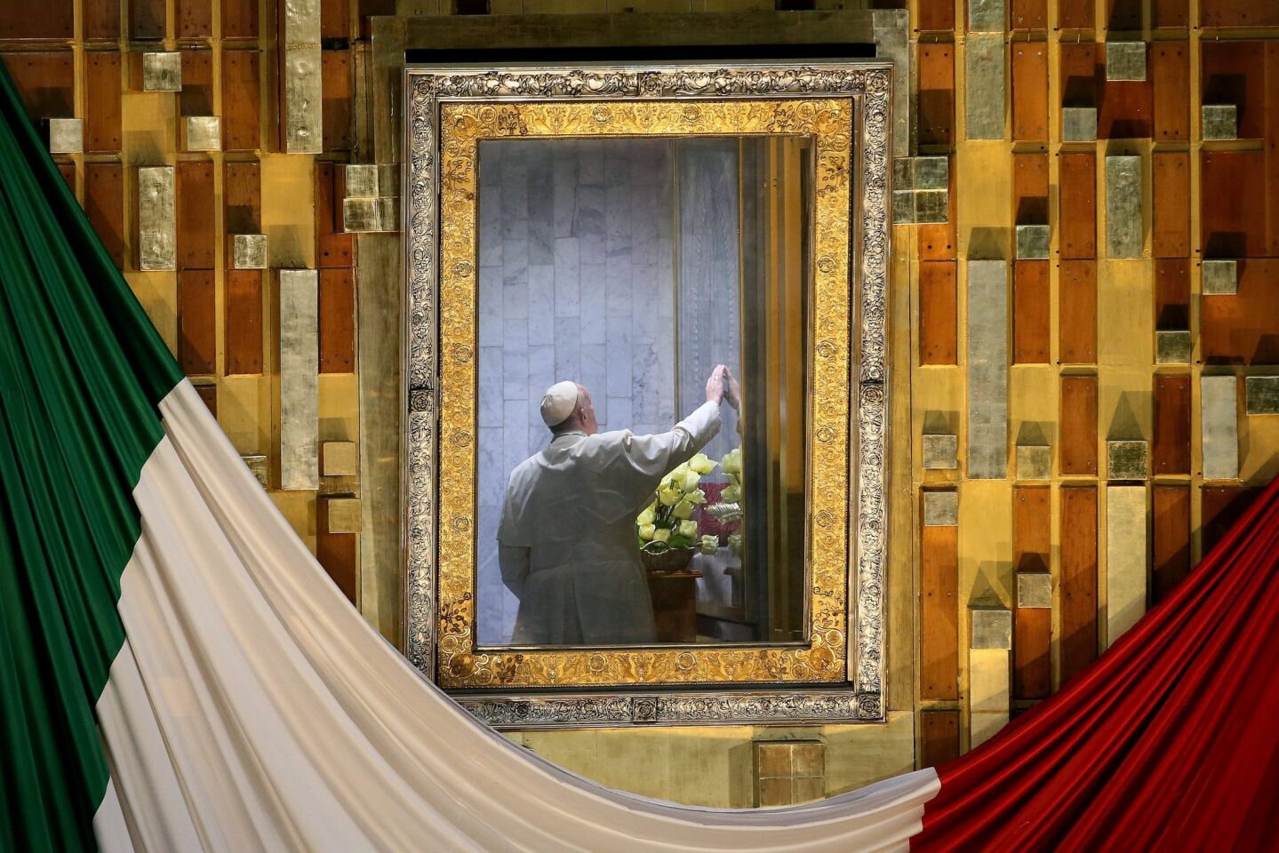 Pope Francis in a room behind the altar to pray before the image of Our Lady of Guadalupe while celebrating Mass at the Basilica of Our Lady of Guadalupe in Mexico City.