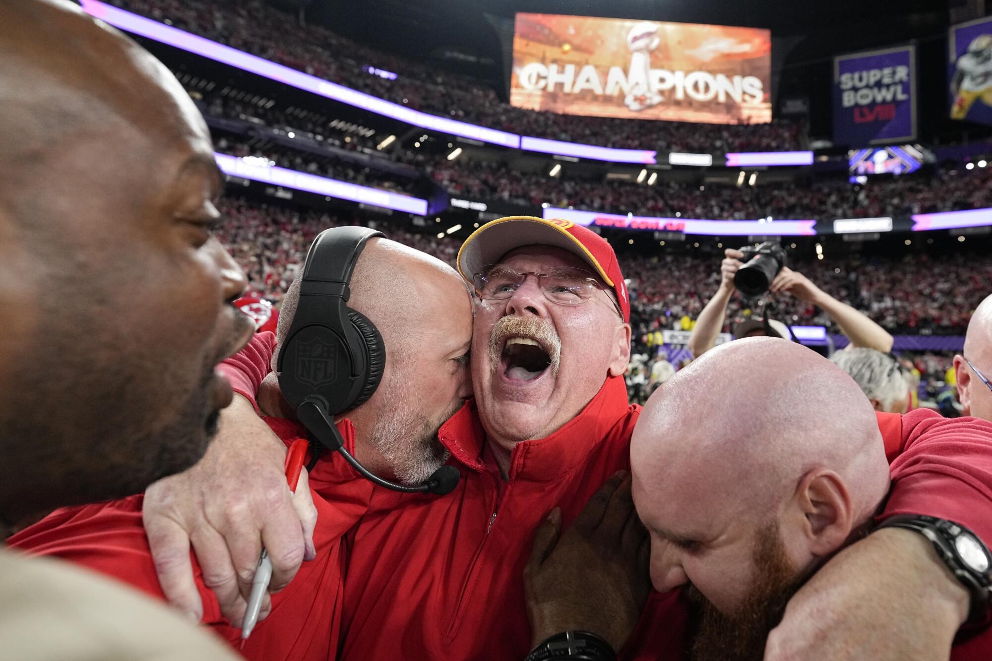 Kansas City Chiefs head coach Andy Reid, center, celebrates with his coaching staff.