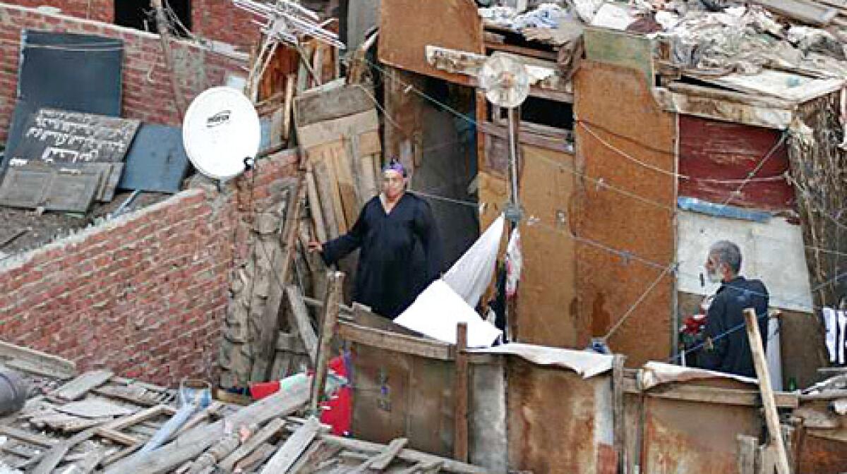 Alia Qotb and husband Ahmed Gaballah have spent decades living atop a building in Cairo. Their makeshift hut has no running water. "It's horrible. Rain. Heat. Insects. There's no toilet up here," Gaballah says.
