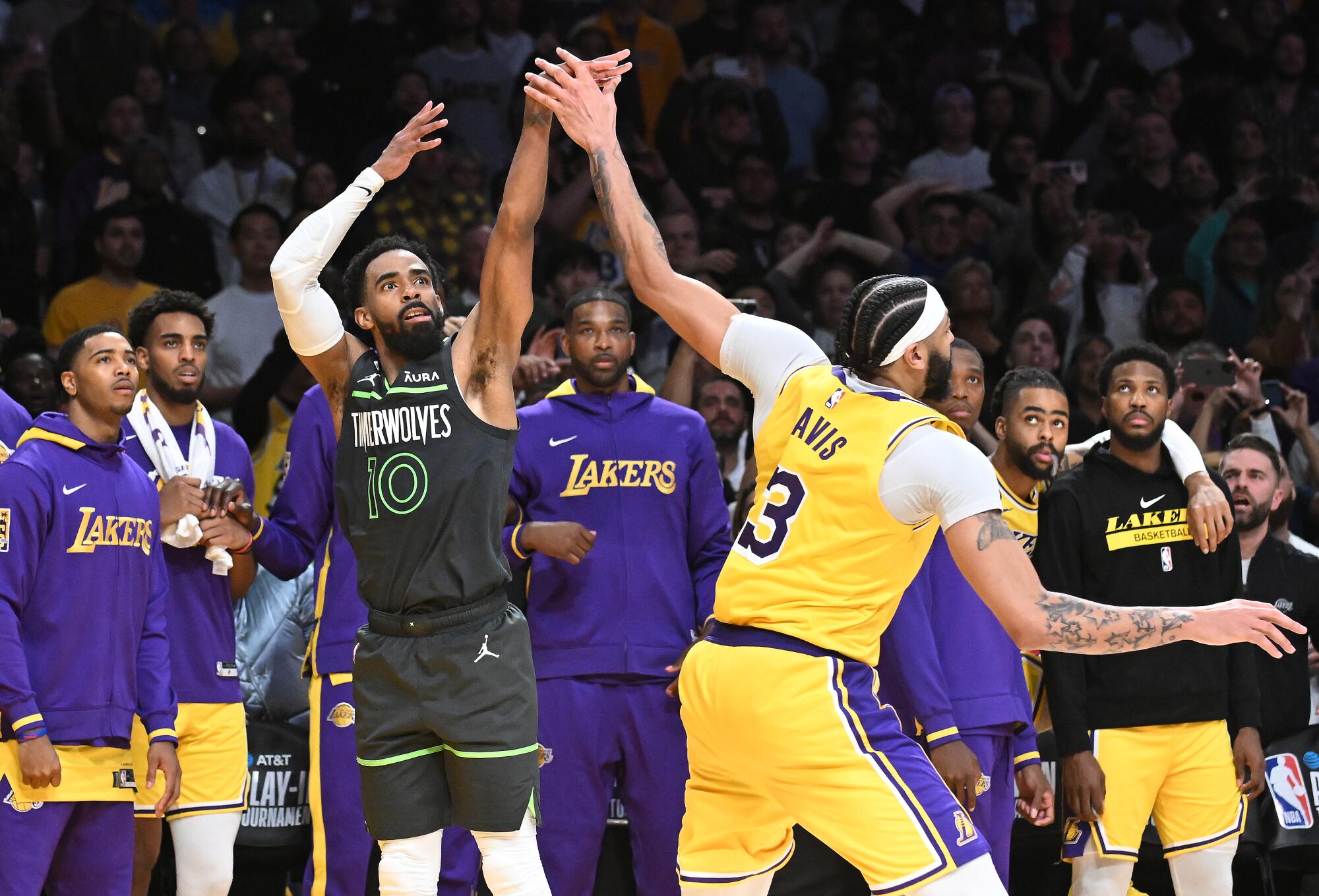 Lakers forward Anthony Davis fouls Timberwolves guard Mike Conley on a three-point attempt.