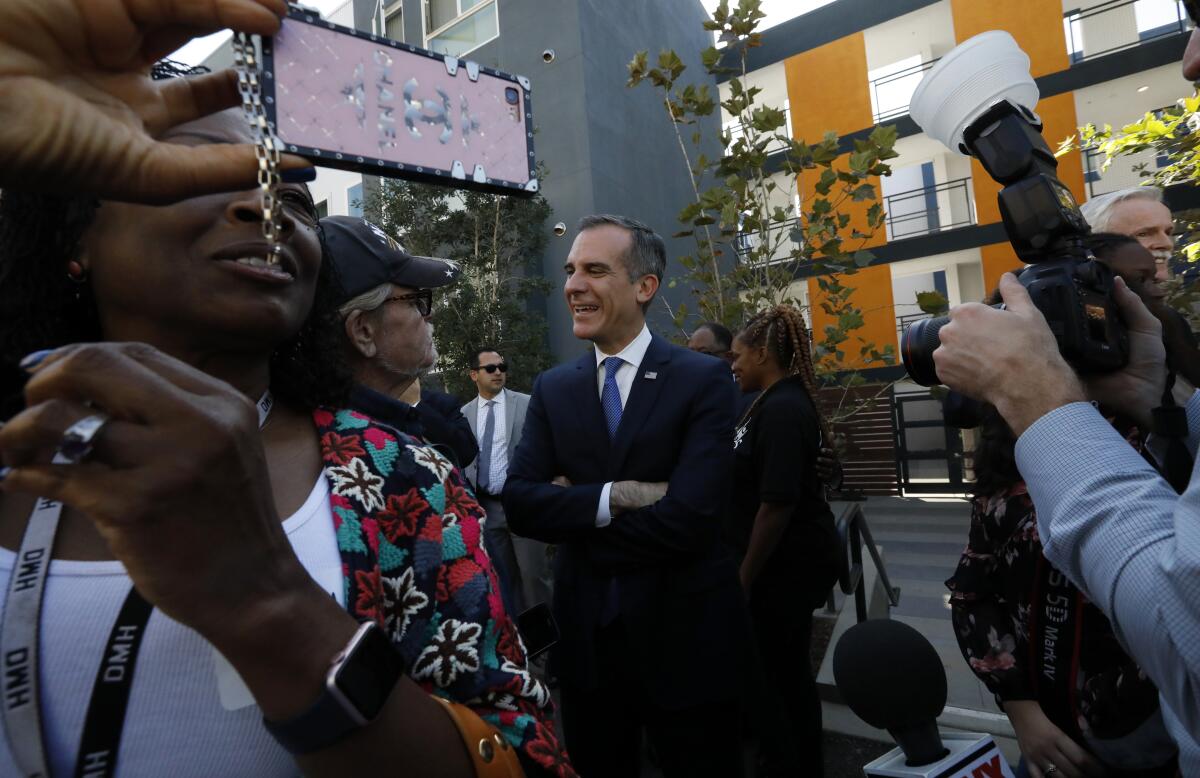 L.A. Mayor Eric Garcetti speaks with residents at the opening of the new apartments in October.