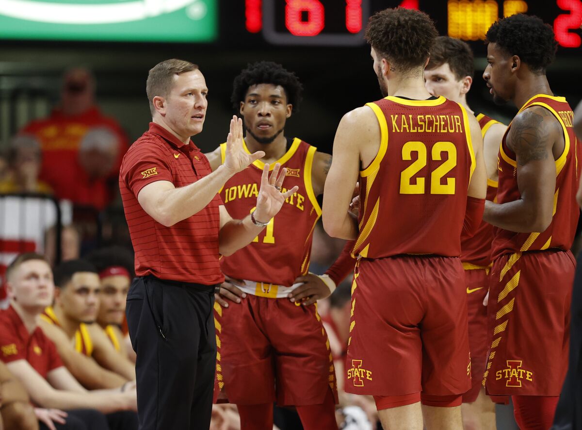 FILE - Iowa State head coach T.J. Otzelberger, left, talks with his team during a timeout in the second half of an NCAA college basketball game against Missouri, Jan. 29, 2022, in Ames, Iowa. Otzelberger has received a contract extension and $500,000 raise after leading the Cyclones to the NCAA Sweet 16 and the third-best turnaround in major college basketball history. "I’m grateful that we are able to reward that success with this extension,” athletic director Jamie Pollard said Wednesday, June 1, 2022. (AP Photo/Matthew Putney, File)