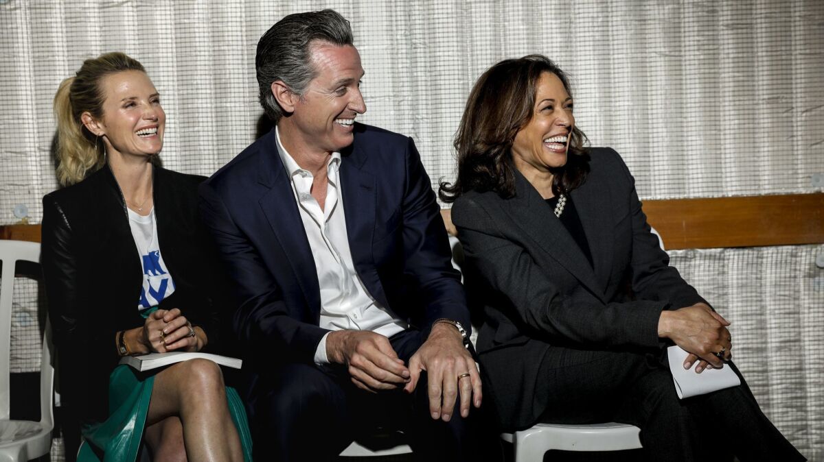 Gov. Gavin Newsom, pictured last year with wife Jennifer Siebel Newsom, could play a pivotal role in the campaign of Sen. Kamala Harris, right.