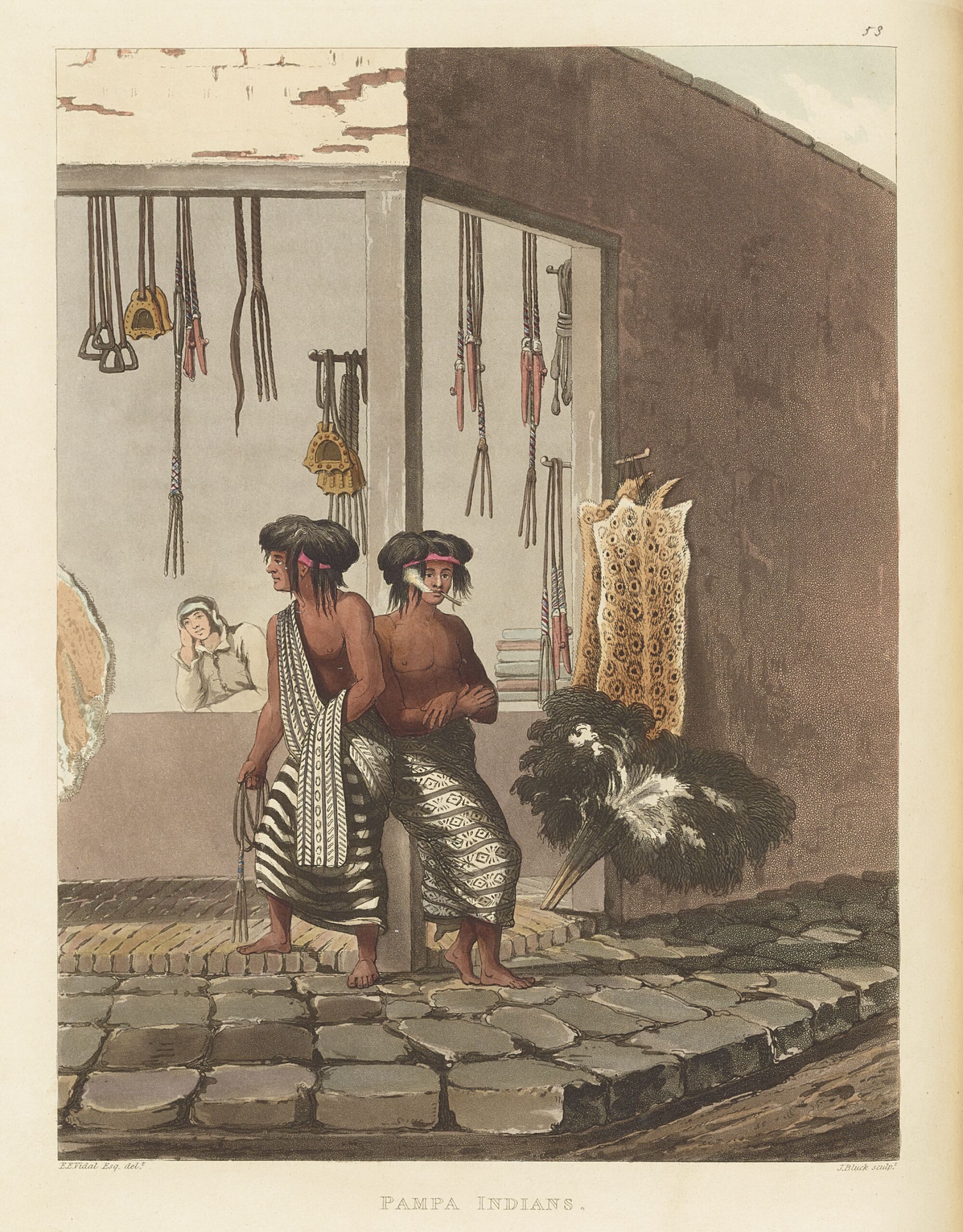 Two Indigenous men in wearing traditional textiles in a geometric print stand on a cobblestone street corner