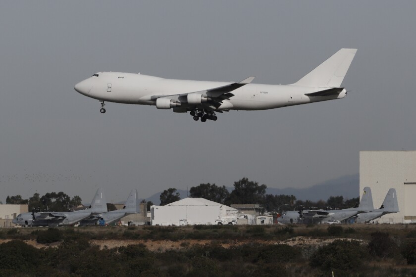 A plane carrying evacuees from the virus zone in China lands at Marine Corps Air Station Miramar Wednesday, Feb. 5, 2020, in San Diego. One of two jets carrying Americans fleeing the virus zone in China landed Wednesday morning at Miramar after first landing at an Air Force base in Northern California. Some will be quarantined at a hotel on the base for 14 days while others will be quarantined at a Southern California military base, officials said. (AP Photo/Gregory Bull)
