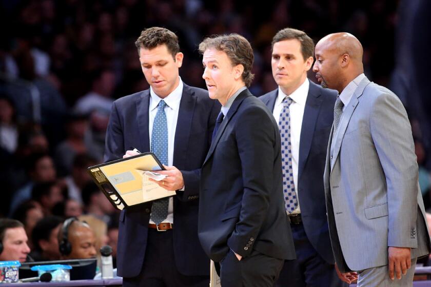 Lakers player development coach Brian Keefe, second from left, joins Coach Luke Walton left, and assistant coaches Mark Madsen and Brian Shaw during a timeout in a Nov. 22 game against the Oklahoma City Thunder.