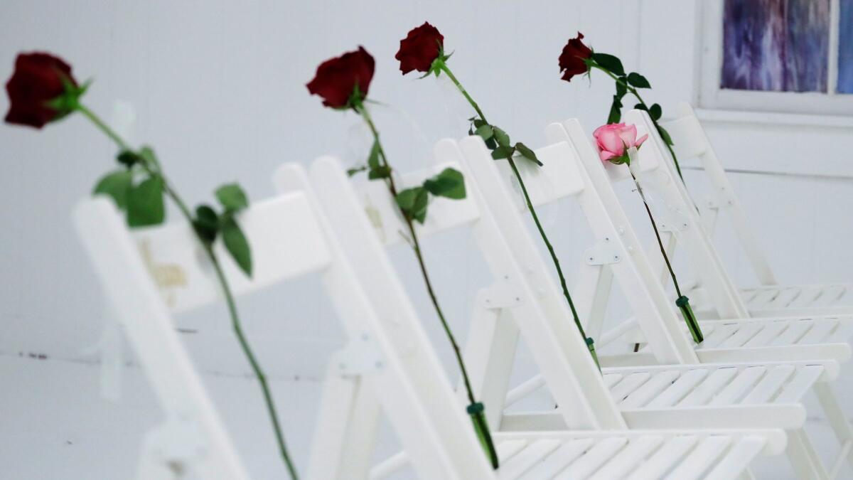 A memorial for the victims of the shooting at First Baptist Church of Sutherland Springs, including 26 white chairs, each with a rose, is displayed in the church on Sunday, a week after the deadly rampage.