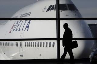 FILE - In this file photo made Jan. 21, 2010, a passenger walks past a Delta Airlines 747 aircraft in McNamara Terminal at Detroit Metropolitan Wayne County Airport in Romulus, Mich. Major airlines are suspending flights to Israel after it formally declared war following a massive attack by Hamas. American Airlines, United Airlines and Delta Air Lines suspended service as the U.S. State Department issued travel advisories for the region citing potential for terrorism and civil unrest. Delta said its Tel Aviv flights have been canceled into this week. (AP Photo/Paul Sancya, File)