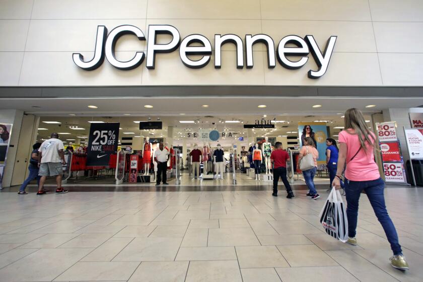 FILE - In this Wednesday, June 7, 2017, file photo, shoppers walk into a J.C. Penney department store in Hialeah, Fla. On Friday, Aug. 11, 2017, J.C. Penney Company, Inc. Holding Company reports earnings. (AP Photo/Alan Diaz, File)
