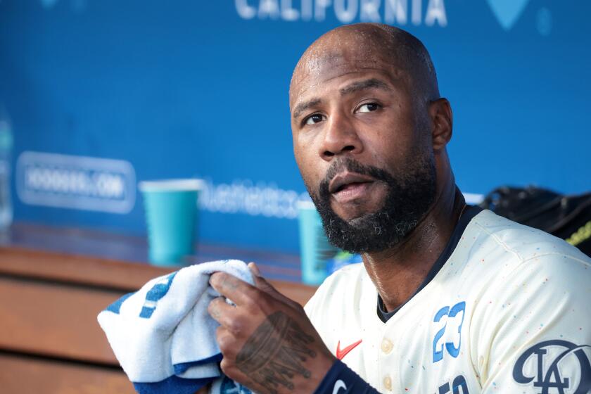 LOS ANGELES, CALIFORNIA-Dodgers Jason Heyward watches form the dugout against the Angels at Dodgers Stadium Saturday. (Wally Skalij/Los Angeles Times)