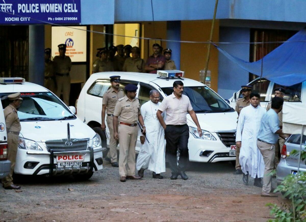 Bishop Franco Mulakkal, center, is escorted by police after being questioned on rape allegations in Kochi, India, on Sept. 19. He was arrested two days later.