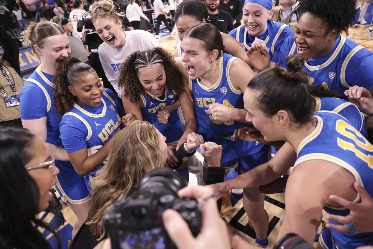 UCLA players celebrate after defeating Stanford in the Pac-12 women's basketball tournament semifinals.