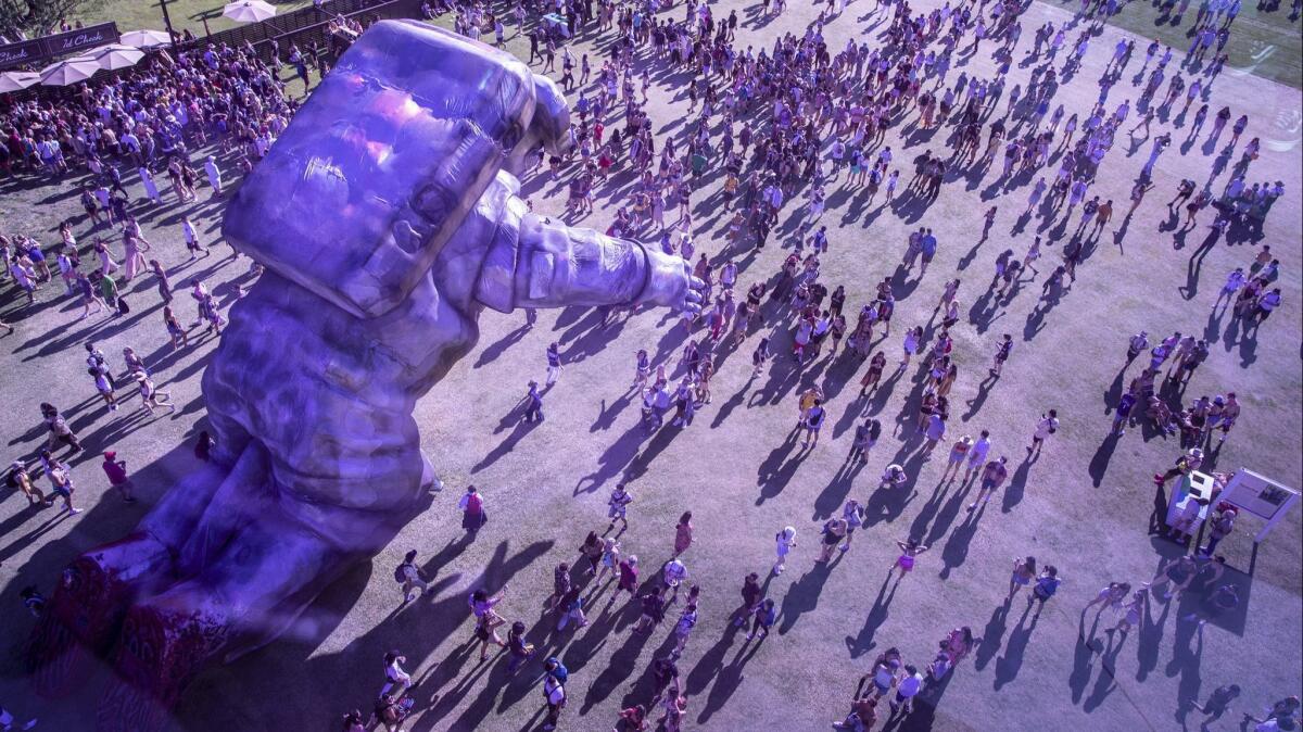 Poetic Kinetics' astronaut sculpture looms over the Coachella crowd.