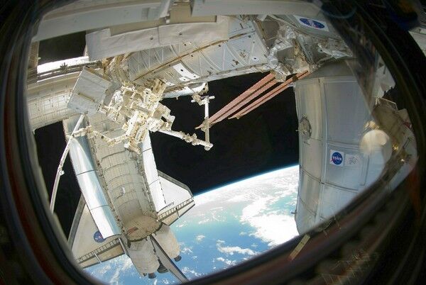 STS-133 space shuttle Discovery at the International Space Station