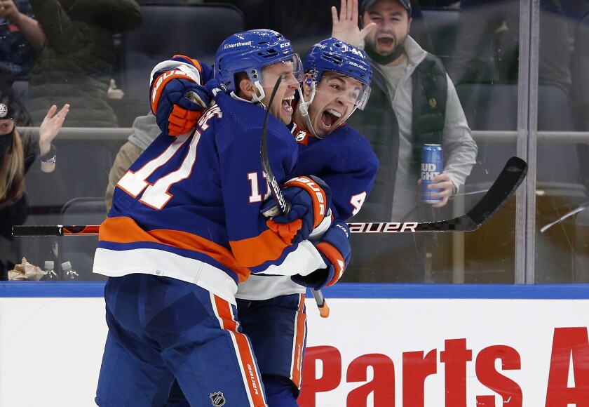 New York Islanders left wing Zach Parise (11) celebrates his shorthanded goal against the New Jersey Devils with Jean-Gabriel Pageau (44) during the second period of an NHL hockey game on Saturday, Dec. 11, 2021, in Elmont, N.Y. (AP Photo/Jim McIsaac)