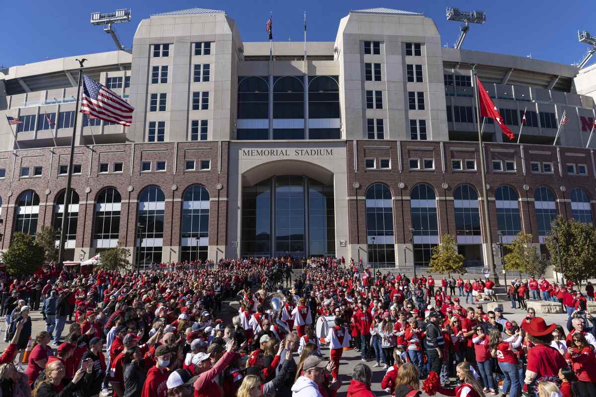 Nebraska fans cheer as the team arrives at Memorial Stadium on Oct. 30, 2021.