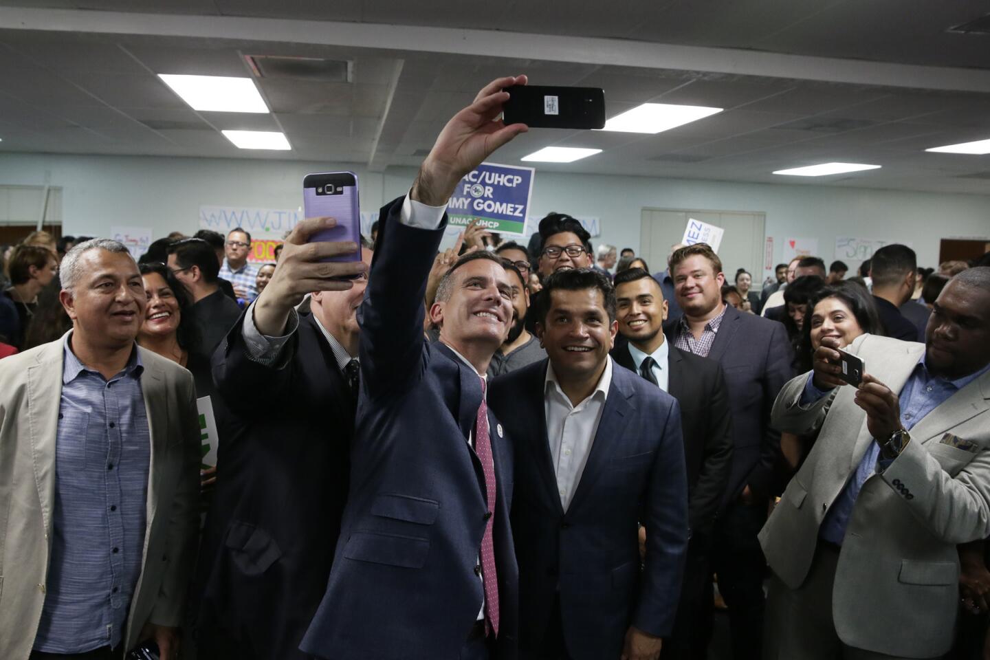 Los Angeles Mayor Eric Garcetti takes a selfie with Assemblyman Jimmy Gomez during Gomez's election night rally for the 34th Congressional District.