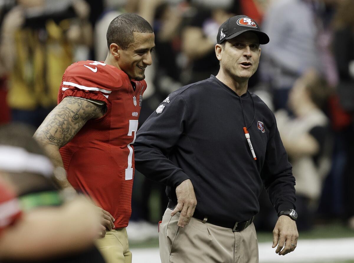 49ers quarterback Colin Kaepernick, left, walks with coach Jim Harbaugh before Super Bowl XLVII 