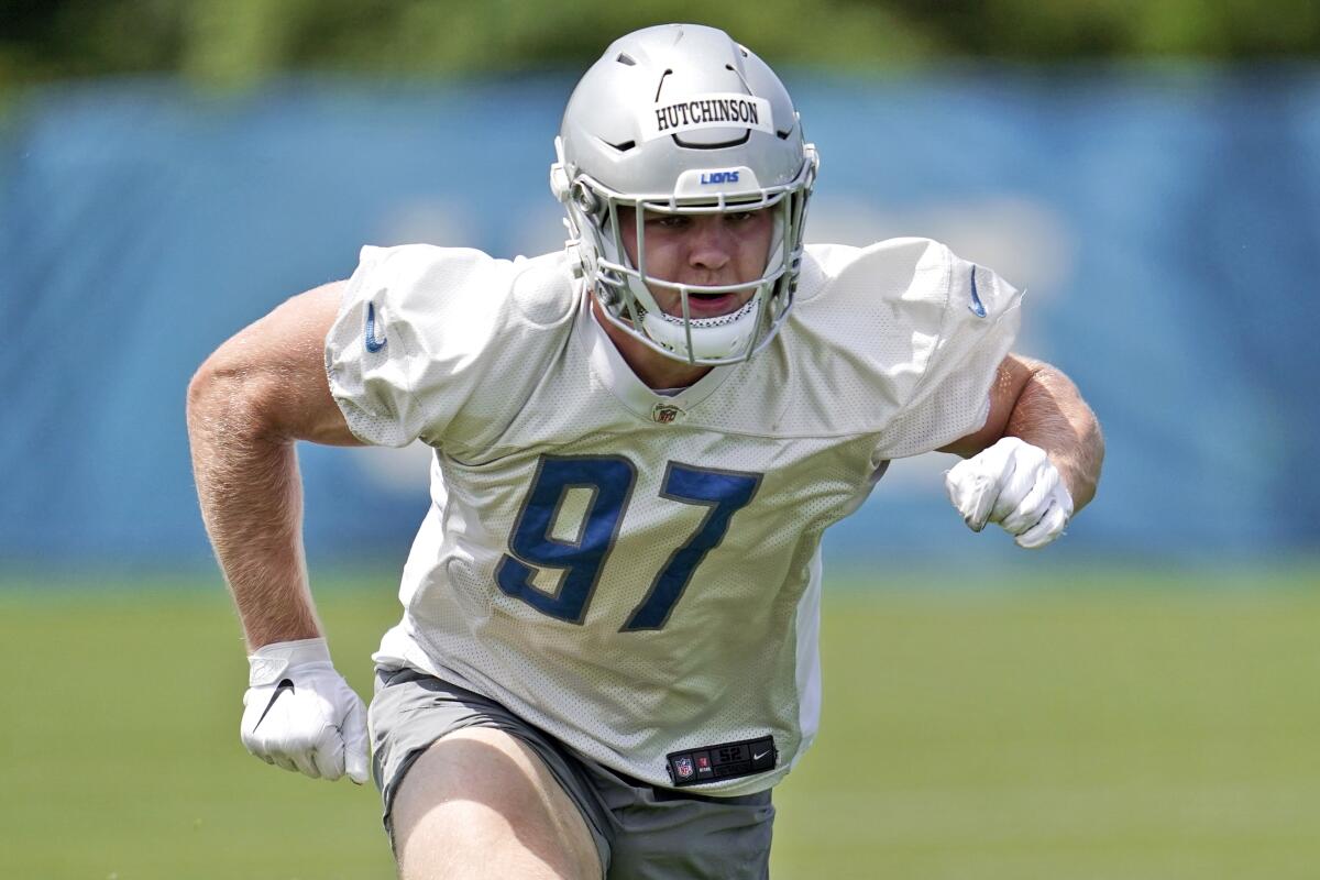 FILE - Detroit Lions defensive end Aidan Hutchinson works out during an NFL football practice in Allen Park, Mich., on June 2, 2022. Hutchinson has humbly been working on his craft on the field, and quietly has been handling his business off the field.(AP Photo/Paul Sancya, File)