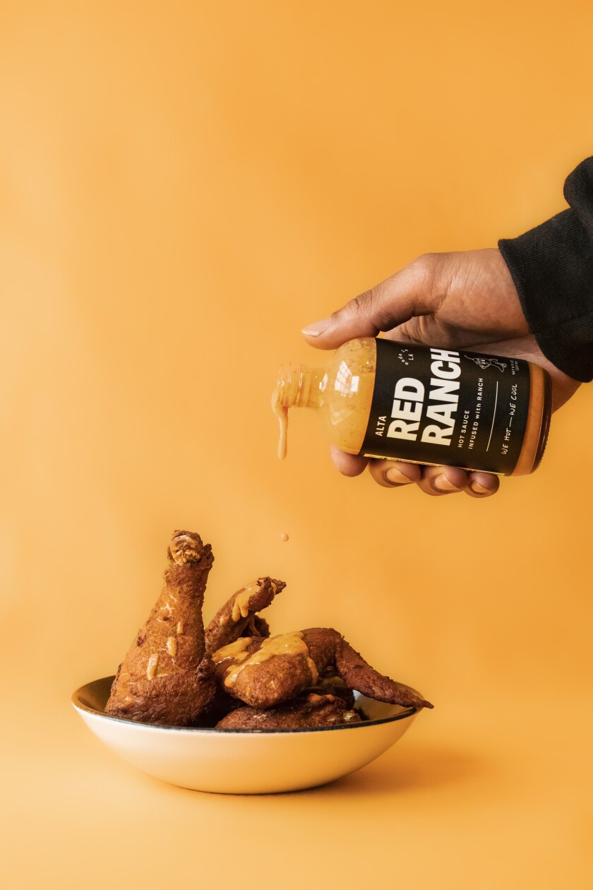 Alta Adams Red Ranch sauce being over fried chicken.