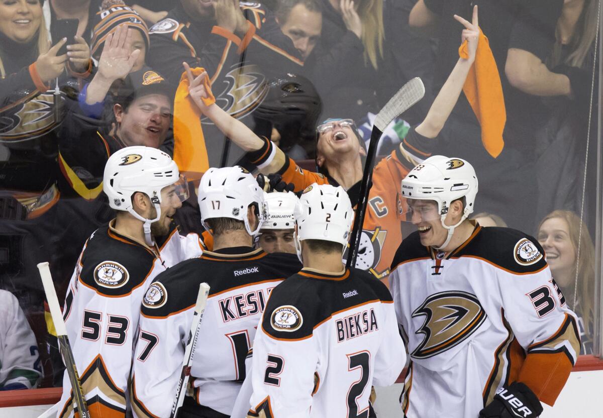 Ducks players, from left, Shea Theodore, Ryan Kesler, Andrew Cogliano, Kevin Bieksa and Jakob Silfverberg celebrate Cogliano's goal against the Vancouver Canucks during the third period.