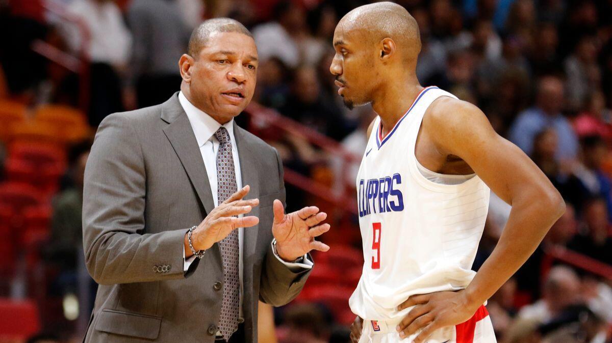 Clippers coach Doc Rivers speaks with guard C.J. Williams during a game against the Miami Heat on Saturday.