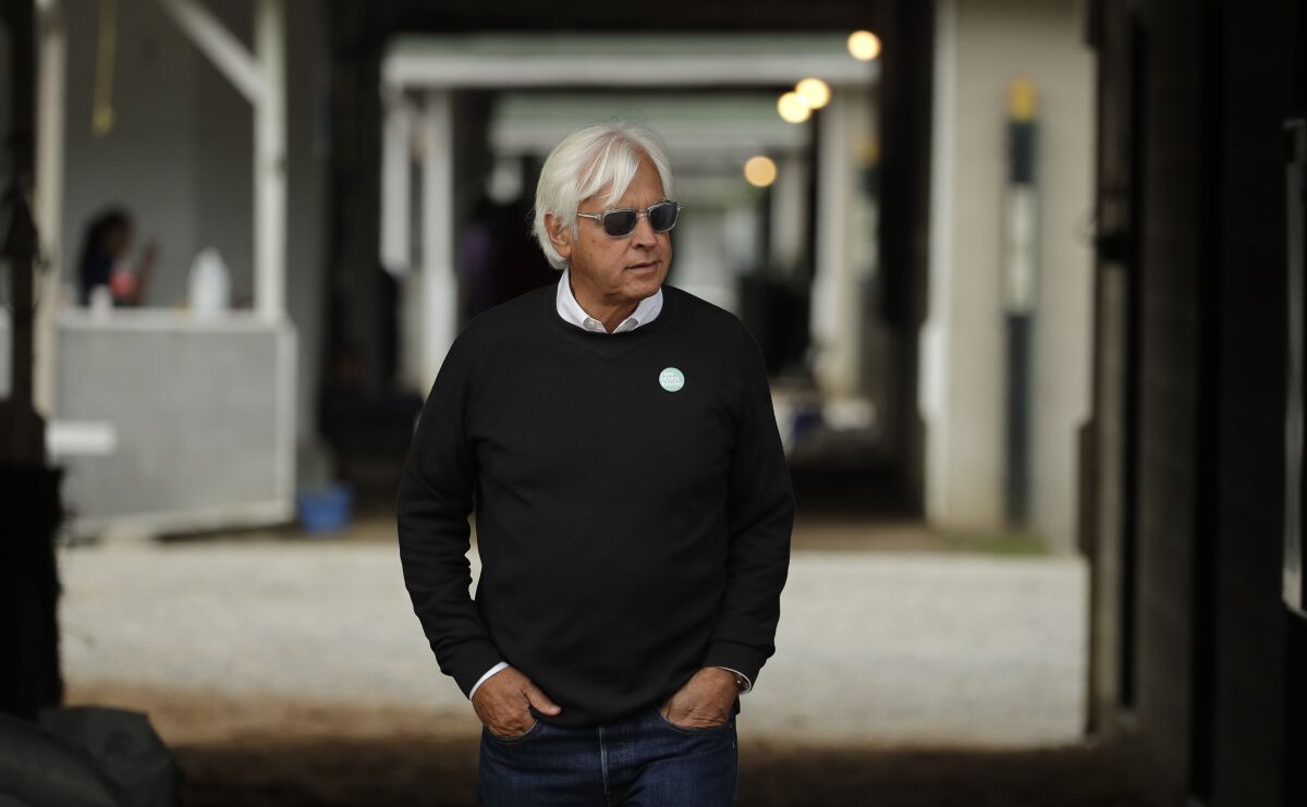 Bob Baffert looks out from his barn before a workout at Churchill Downs.