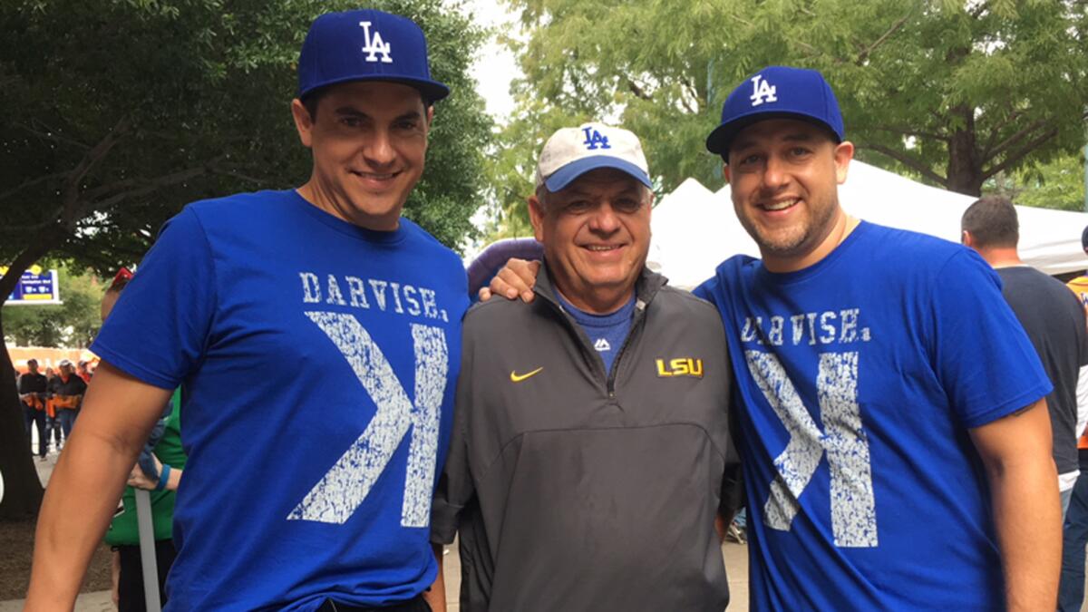 John Dudley is flanked by sons Chad, left, and Kalin before Game 3.