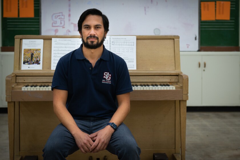 A man sits in front of a piano