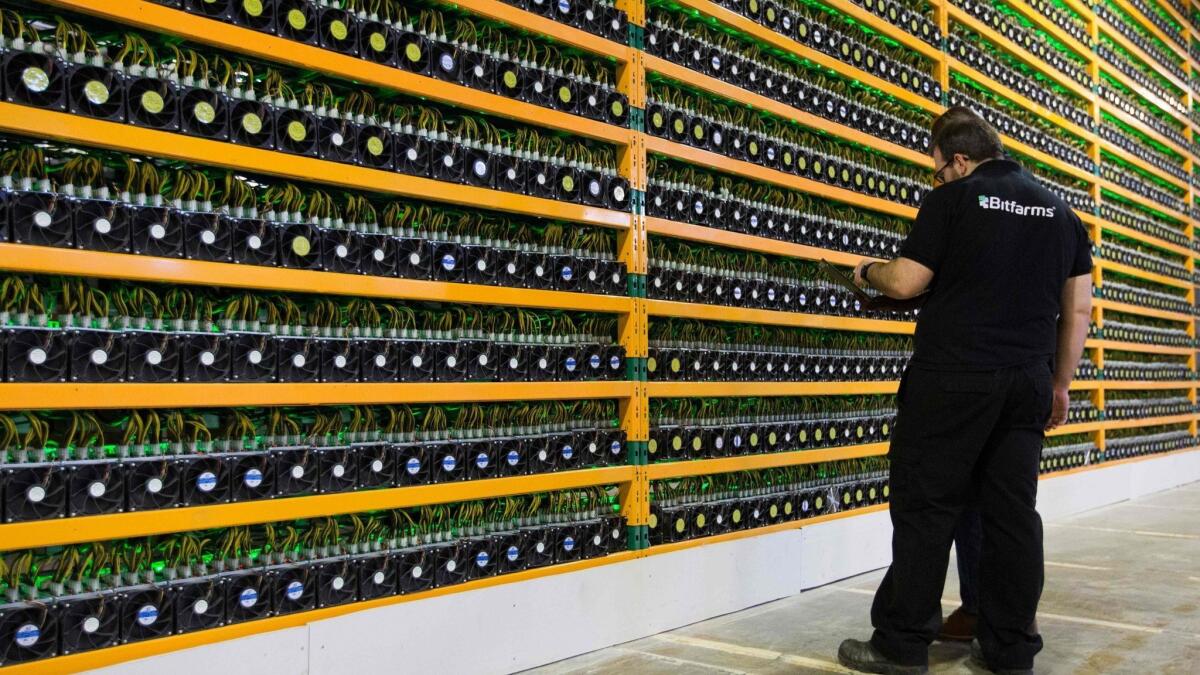 Technicians inspect bitcoin mining servers at Bitfarms in St. Hyacinthe, Canada.