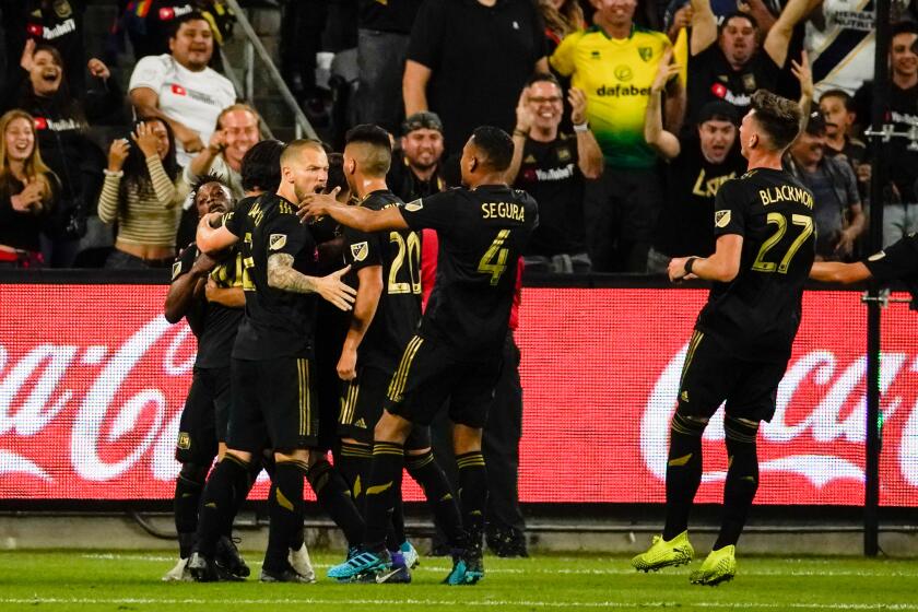 LOS ANGELES, CALIF. - OCTOBER 24: The Los Angeles FC celebrate the first goal of the game, scored by Los Angeles FC forward Carlos Vela (10) during a match between the Los Angeles FC and the Los Angeles Galaxy at Banc of California Stadium, on Thursday, Oct. 24, 2019 in Los Angeles, Calif. (Kent Nishimura / Los Angeles Times)