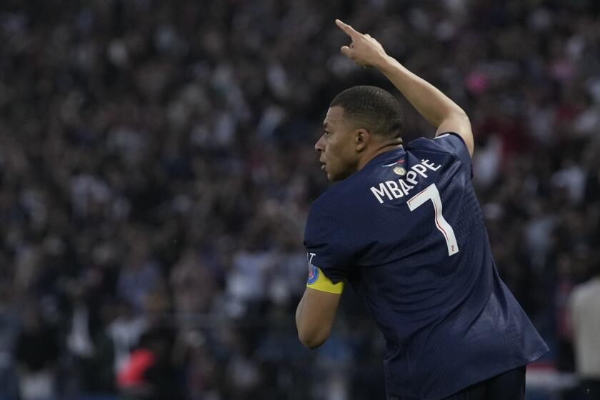 PSG's Kylian Mbappe celebrates after scoring his side's opening goal during the French League One soccer match between Paris Saint-Germain and Toulouse at the Parc des Princes stadium in Paris, Sunday, May 12, 2024. (AP Photo/Christophe Ena)