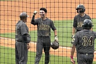 Kennedy's Abel Castillo is all smiles after RBI double in the seventh while greeting coach Andy Rodriguez 