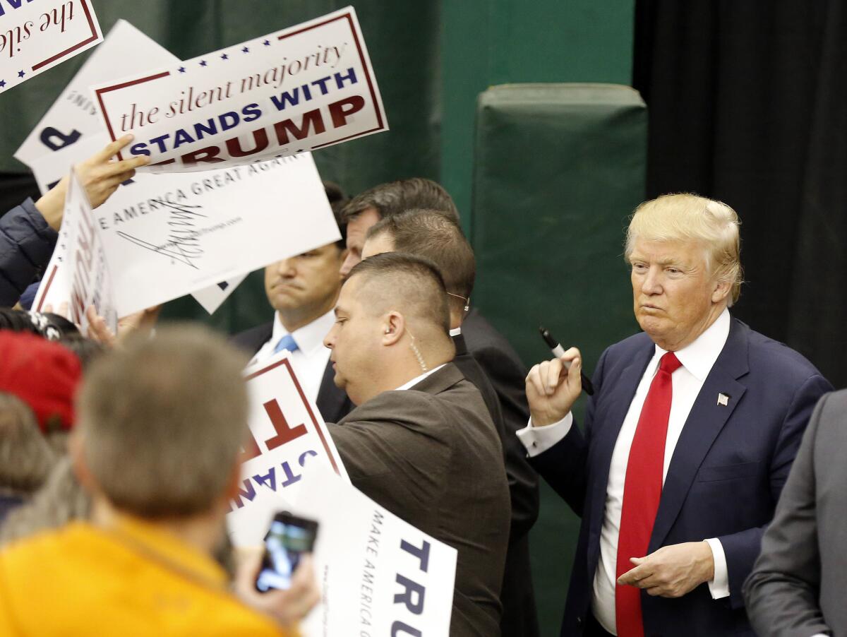 Supporters meet Republican presidential front-runner Donald Trump on Tuesday in Waterville Valley, N.H. His supporters appear solidly behind him despite criticisms.
