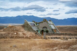 An Earthship appears to be coming out of the ground in Taos, N.M.