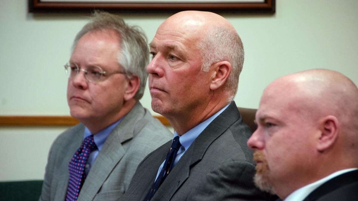 Congressman-elect Greg Gianforte, center, sits with William Mercer, left, and Todd Whipple on Monday during his court hearing in Bozeman, Mont.