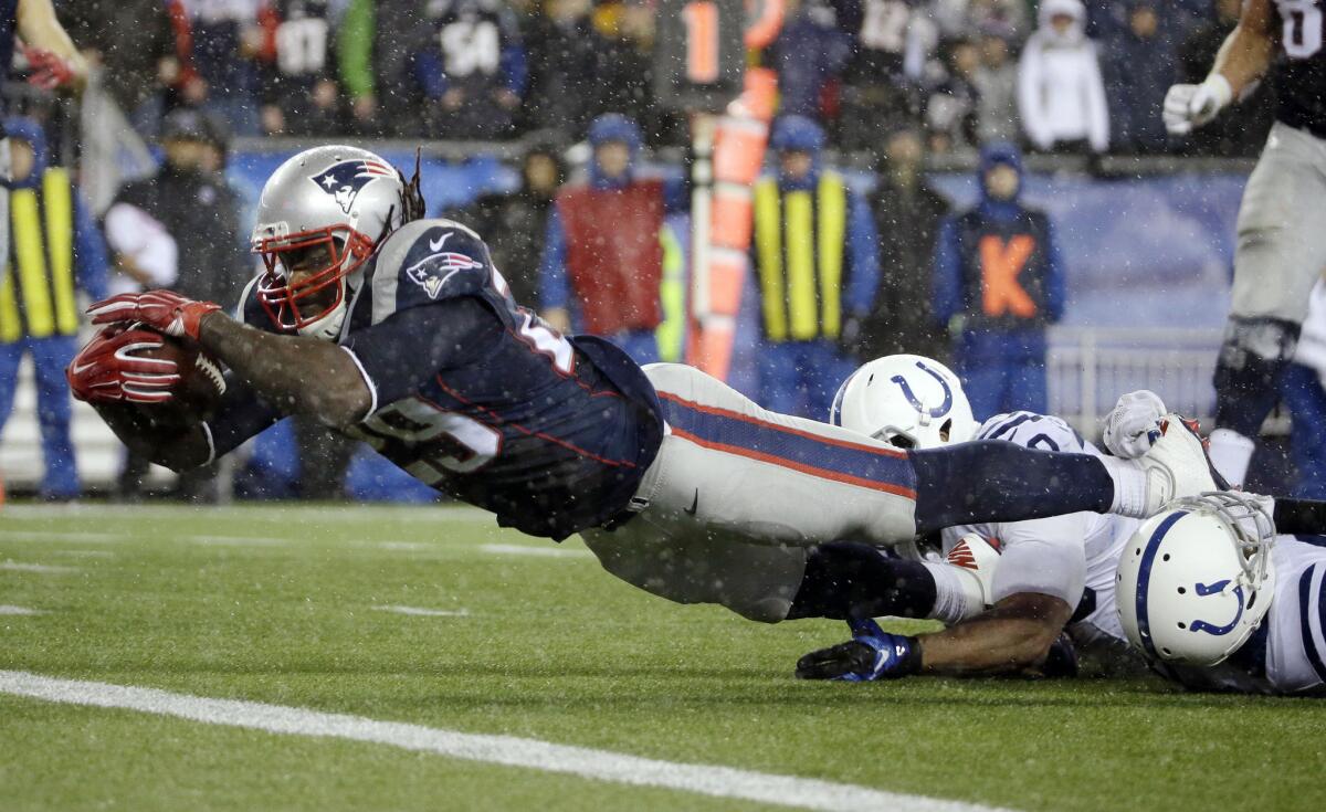 Patriots running back LeGarrette Blount stretches to get the ball across the goal line to finish a 13-yard touchdown run against the Colts in the AFC championship game on Jan. 18, 2015.