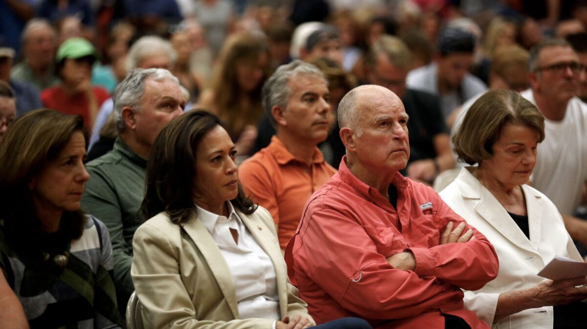 Gov. Jerry Brown, center, and U.S. Sens. Kamala Harris, left, and Dianne Feinstein attend a community meeting at Santa Rosa High School.