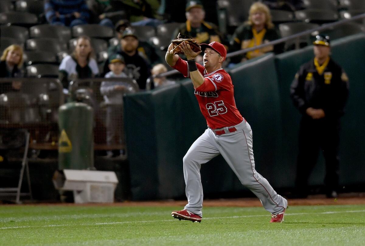 Angels outfielder Daniel Nava (25) makes a running catch of a fly ball in the fifth inning of a game against the Athletics on Apr. 11.